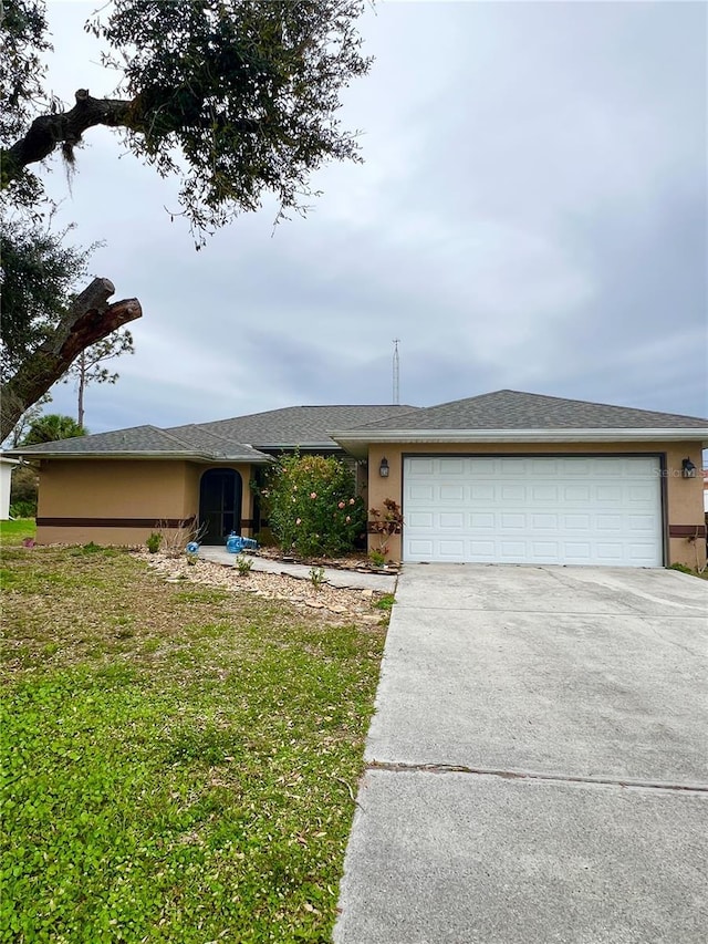 ranch-style home with driveway, an attached garage, and stucco siding