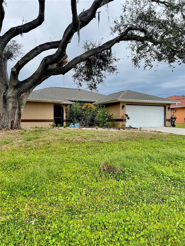 ranch-style home featuring driveway, a front lawn, an attached garage, and stucco siding