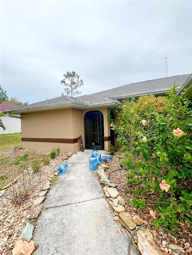 property entrance featuring stucco siding