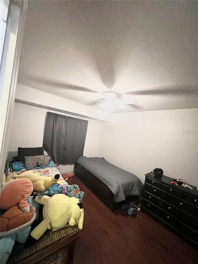 bedroom with a textured ceiling and ceiling fan