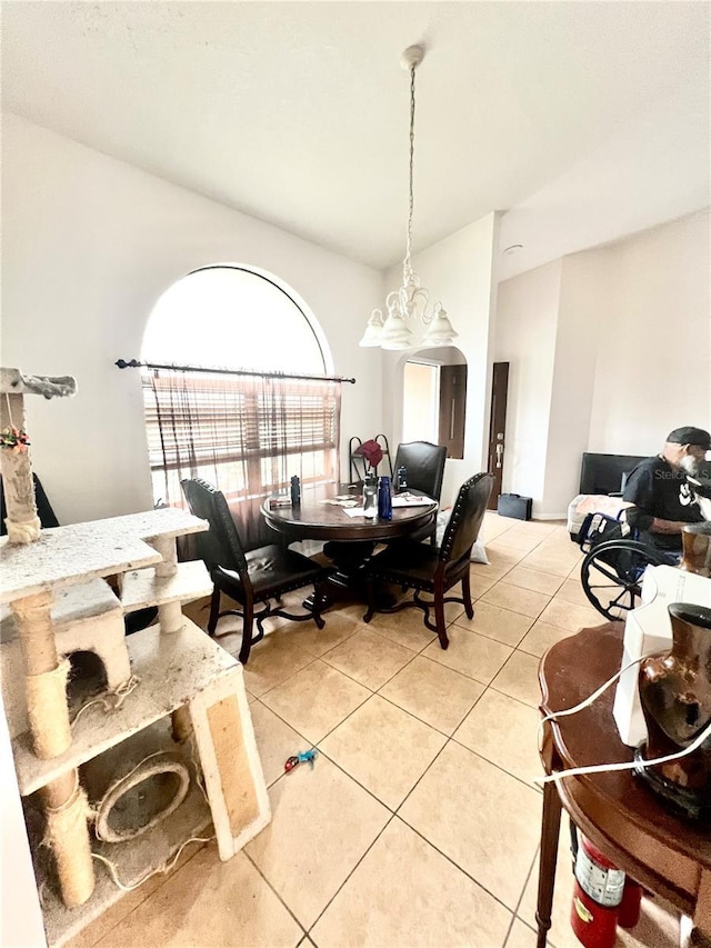 dining area with a chandelier and light tile patterned floors