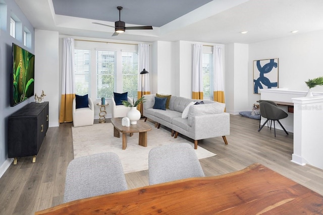 4717 W Mccoy St Unit 18, Tampa, FL 33616 - living area featuring healthy amount of natural light, a tray ceiling, light wood-style flooring, baseboards, and recessed lighting