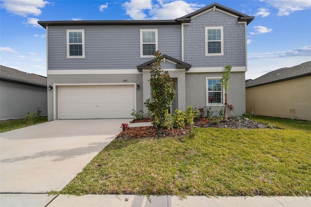 traditional home with stucco siding, a front yard, a garage, and driveway