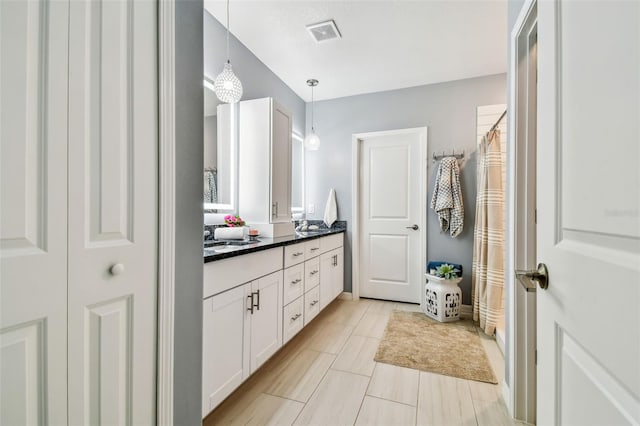 bathroom with visible vents and vanity