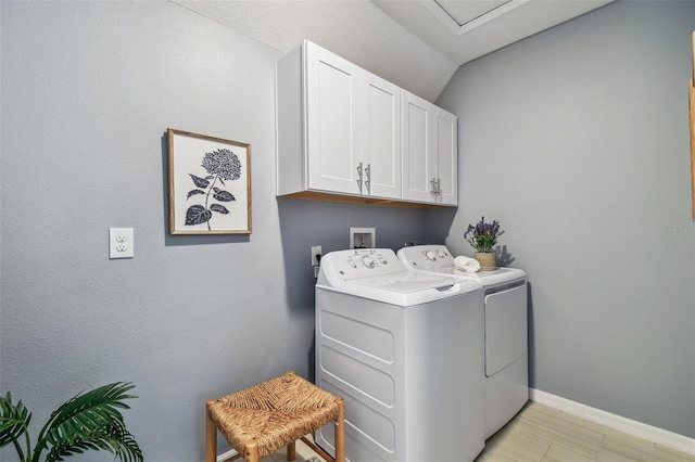 laundry room with baseboards, cabinet space, and washing machine and clothes dryer