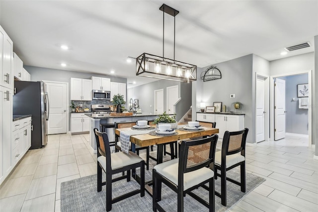 dining room featuring visible vents, recessed lighting, stairway, and baseboards