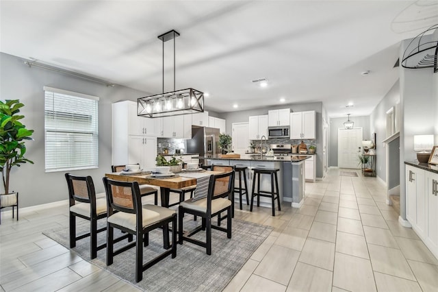 dining space with recessed lighting, visible vents, and baseboards