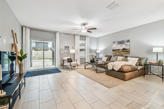 living room with visible vents and ceiling fan