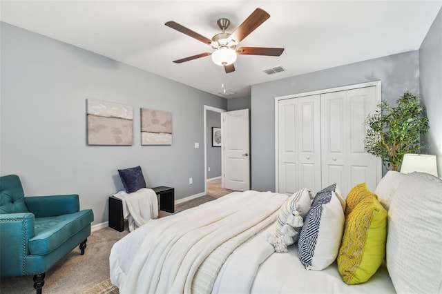 bedroom with a closet, visible vents, carpet flooring, and baseboards