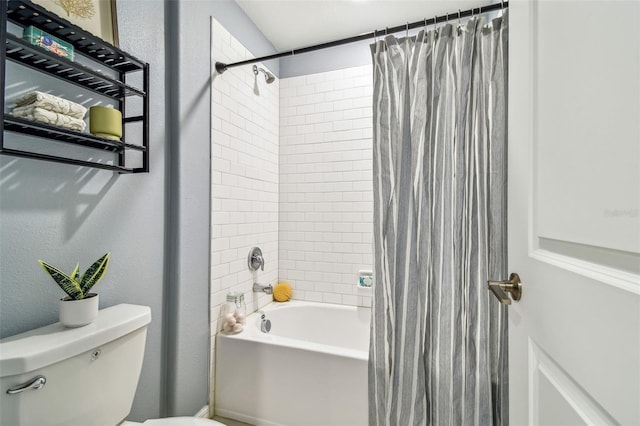 bathroom with shower / bath combination with curtain, toilet, and a textured wall