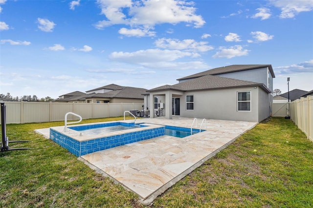 view of pool featuring a lawn, an in ground hot tub, a fenced backyard, and a patio