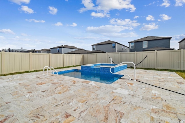 view of swimming pool with a fenced backyard, a fenced in pool, an in ground hot tub, and a patio