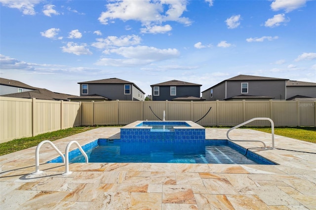 view of swimming pool with a patio area, a pool with connected hot tub, and a fenced backyard