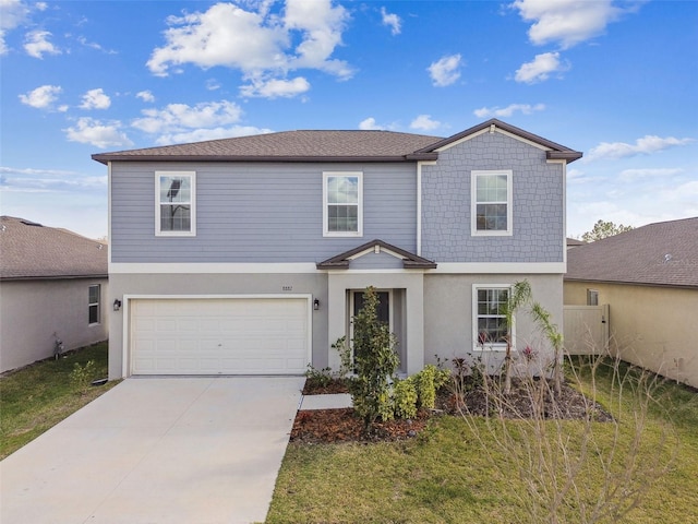 traditional home with stucco siding, concrete driveway, and a garage