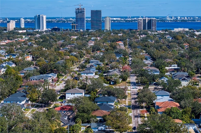 birds eye view of property featuring a view of city and a water view