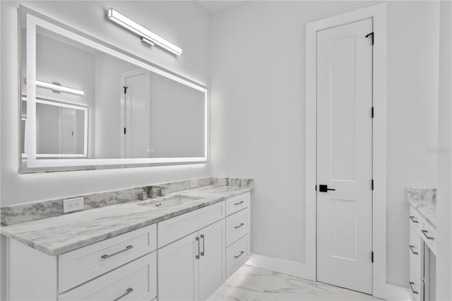 bathroom with marble finish floor and vanity