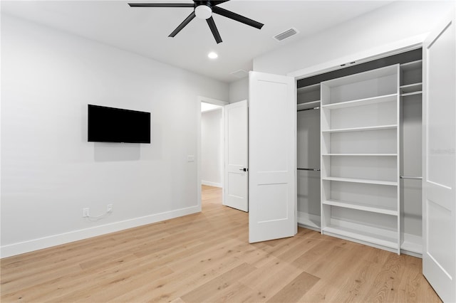 unfurnished bedroom featuring light wood finished floors, baseboards, visible vents, ceiling fan, and a closet