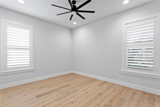 spare room with recessed lighting, wood finished floors, a ceiling fan, and baseboards