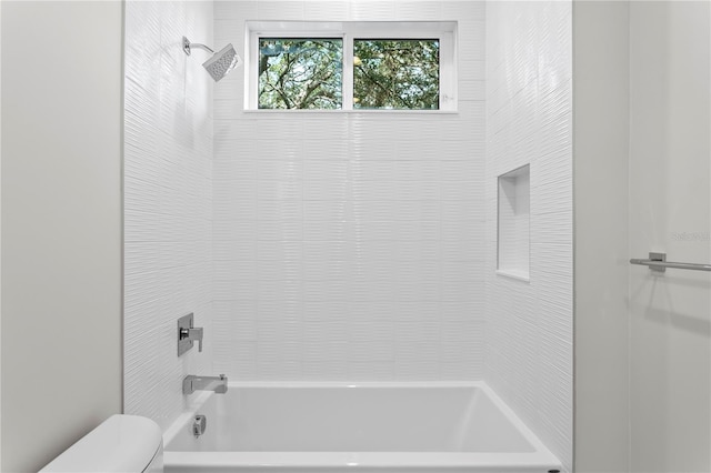 full bathroom with washtub / shower combination and toilet