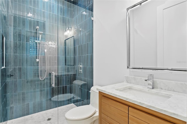 full bathroom with toilet, a shower stall, and vanity