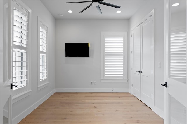 interior space featuring light wood finished floors, recessed lighting, a wealth of natural light, and baseboards