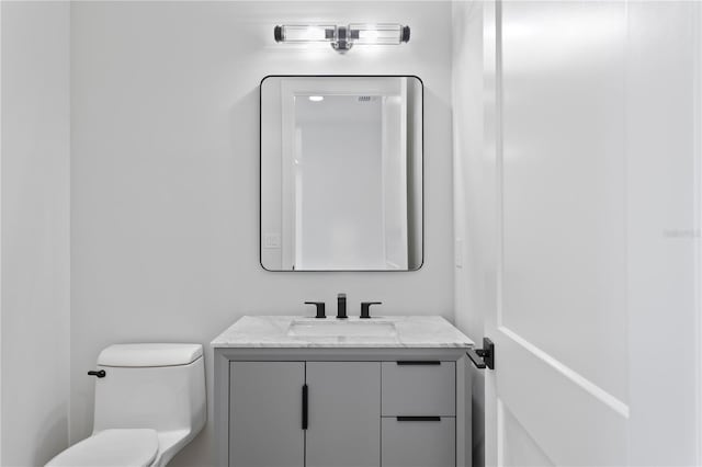 bathroom with toilet and vanity