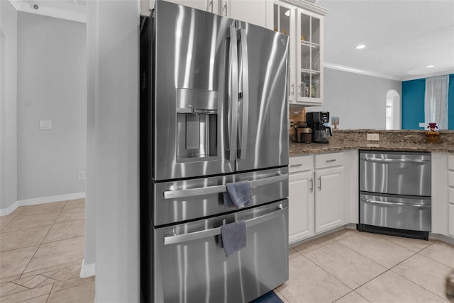 kitchen with stainless steel fridge, glass insert cabinets, white cabinets, and light tile patterned flooring