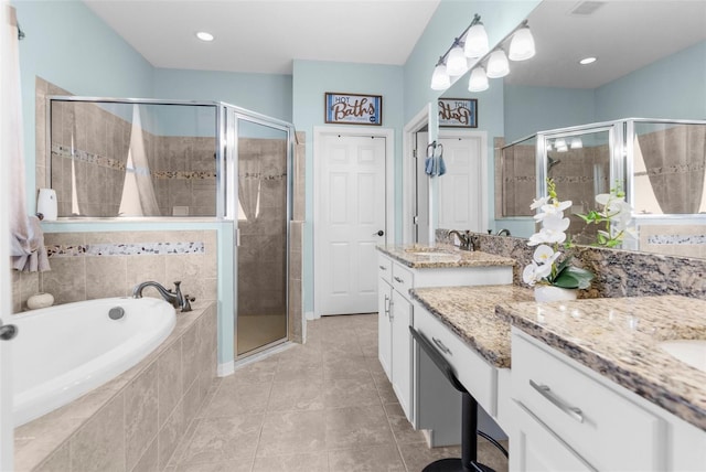 bathroom with a stall shower, tile patterned floors, a bath, and vanity