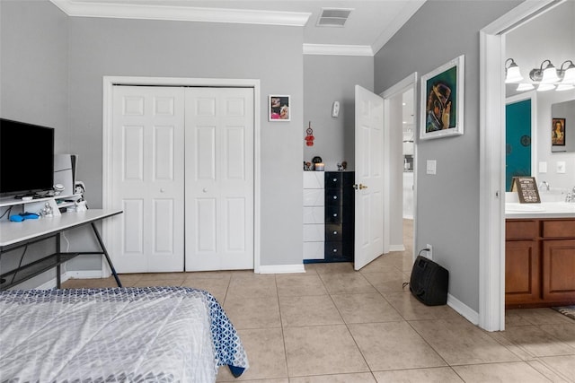 bedroom with light tile patterned flooring, visible vents, baseboards, ornamental molding, and a closet