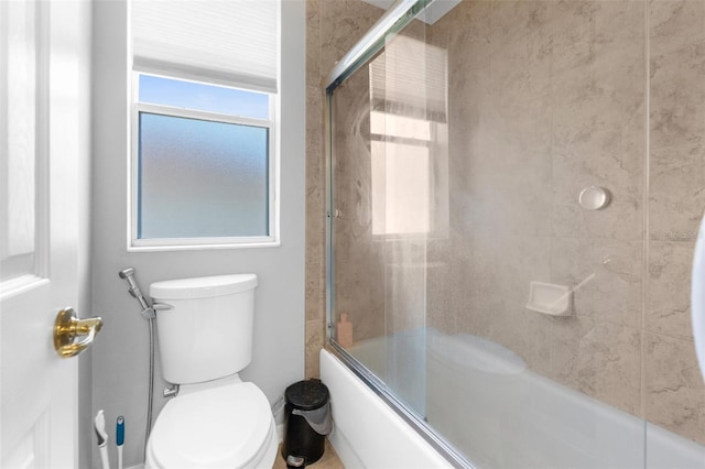 full bath with toilet, plenty of natural light, and enclosed tub / shower combo