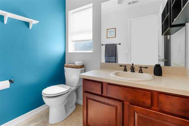 bathroom with baseboards, visible vents, toilet, tile patterned floors, and vanity