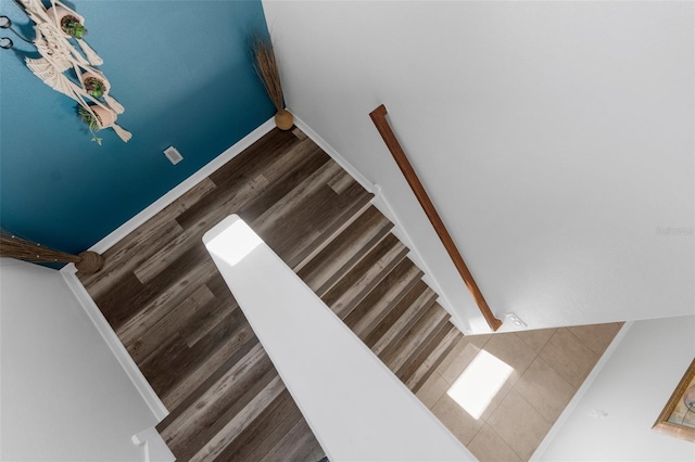 stairs featuring baseboards and wood finished floors