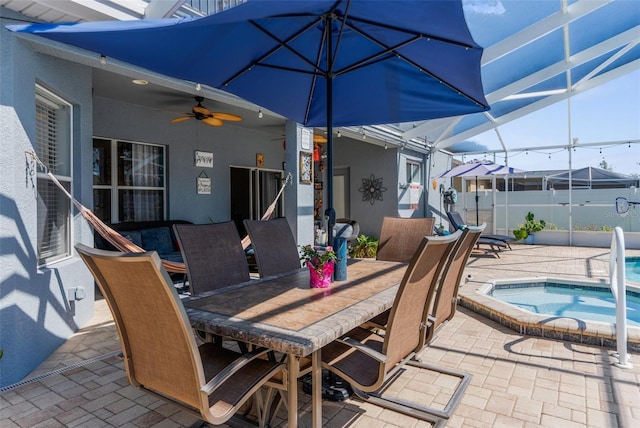 view of patio / terrace with a fenced in pool, outdoor dining area, glass enclosure, ceiling fan, and an in ground hot tub