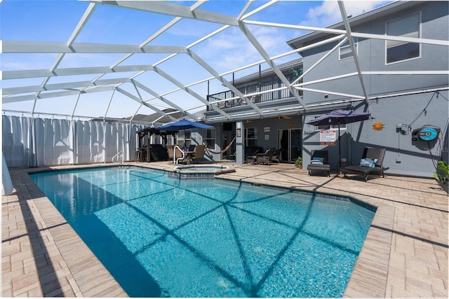 view of swimming pool with a patio area, a lanai, and a pool with connected hot tub