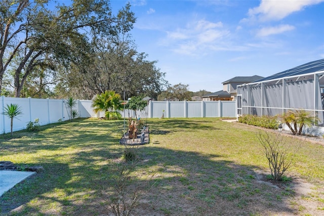 view of yard featuring a lanai and a fenced backyard