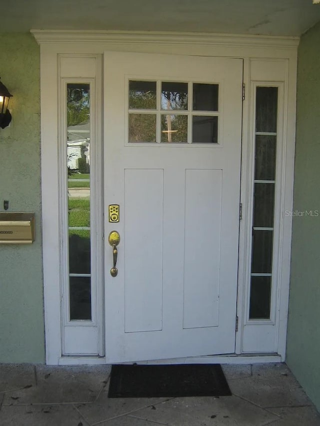 view of exterior entry with stucco siding