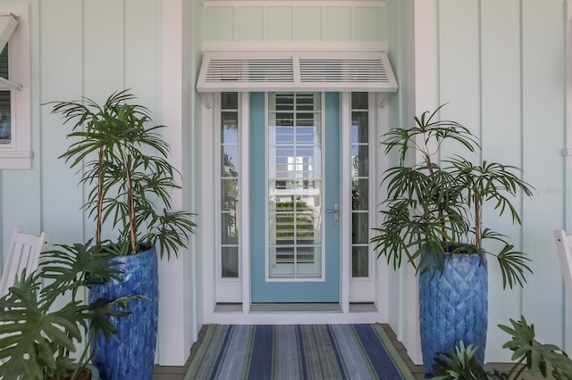 doorway to property featuring board and batten siding