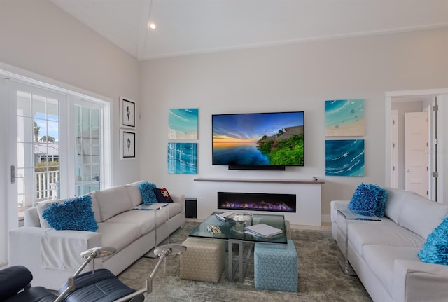 living area featuring a warm lit fireplace and carpet flooring