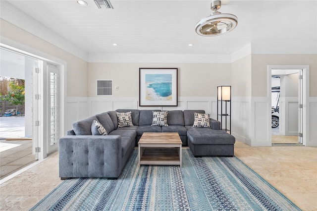 living area featuring recessed lighting, crown molding, visible vents, a decorative wall, and wainscoting