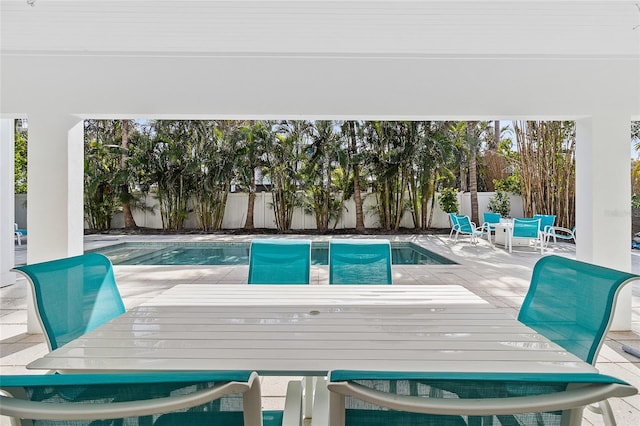 view of swimming pool with a patio, a fenced backyard, outdoor dining area, and a fenced in pool