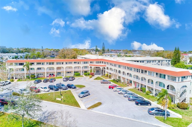 view of building exterior with uncovered parking