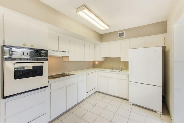 kitchen with under cabinet range hood, white appliances, a sink, visible vents, and light countertops