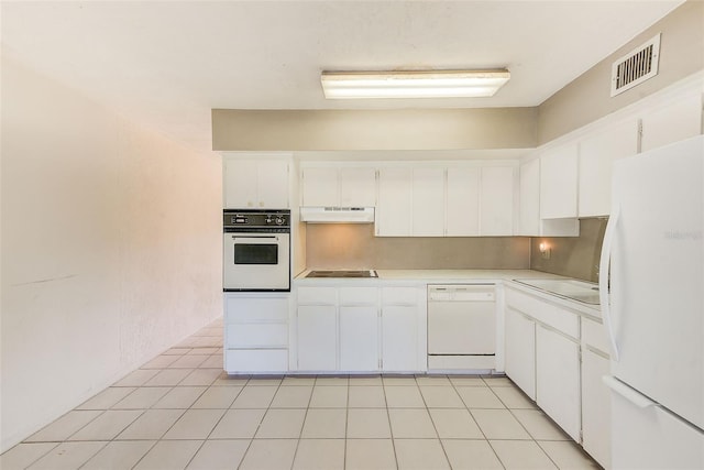 kitchen with white appliances, visible vents, light countertops, under cabinet range hood, and white cabinetry