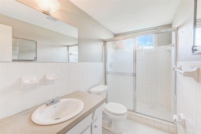 bathroom with toilet, a shower stall, tile walls, and tile patterned floors