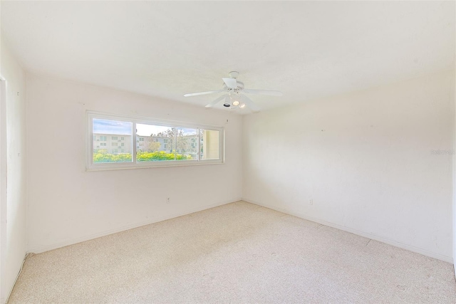 unfurnished room with light carpet and a ceiling fan