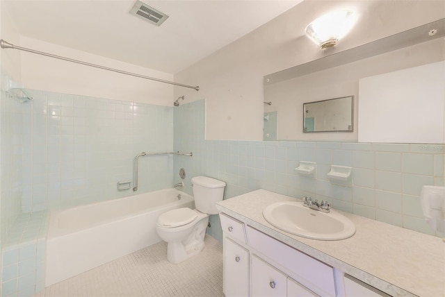 full bathroom featuring tile walls, visible vents, shower / bathing tub combination, toilet, and tile patterned floors