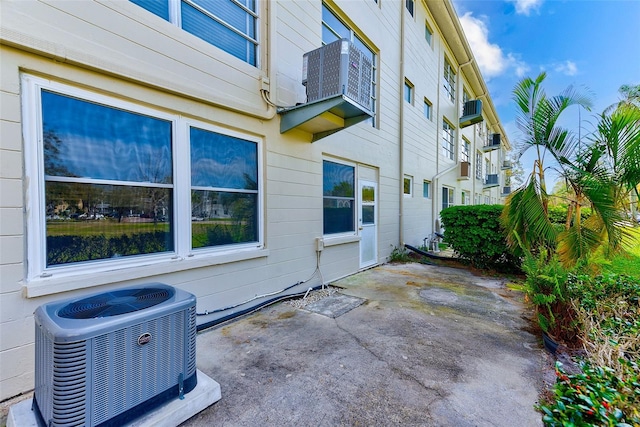 view of home's exterior with a patio area and central AC