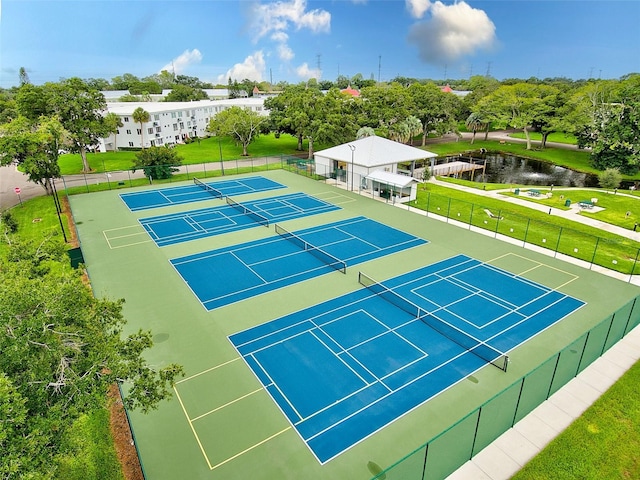 view of sport court featuring a lawn and fence