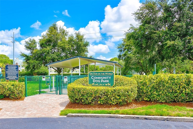 view of property's community featuring a carport, fence, and a gate