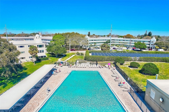 pool with a patio and fence